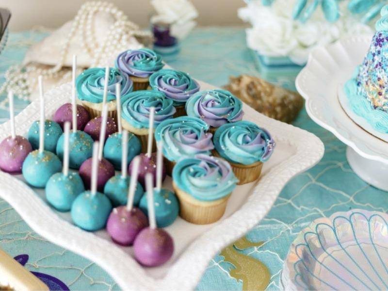 Dessert display with swirled cupcakes and cake pops