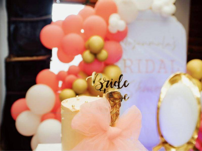Shower dessert table with coral, white and gold balloons